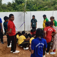 The children busy planting local tree seeds in  pouches